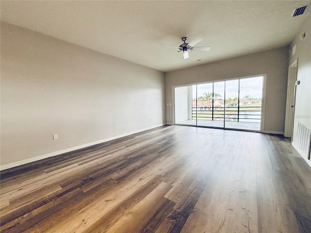 spare room featuring ceiling fan and dark hardwood / wood-style floors