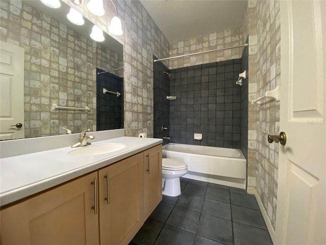 full bathroom with tiled shower / bath combo, toilet, tile patterned flooring, and vanity