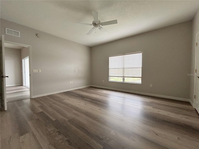 unfurnished room featuring ceiling fan and dark hardwood / wood-style floors