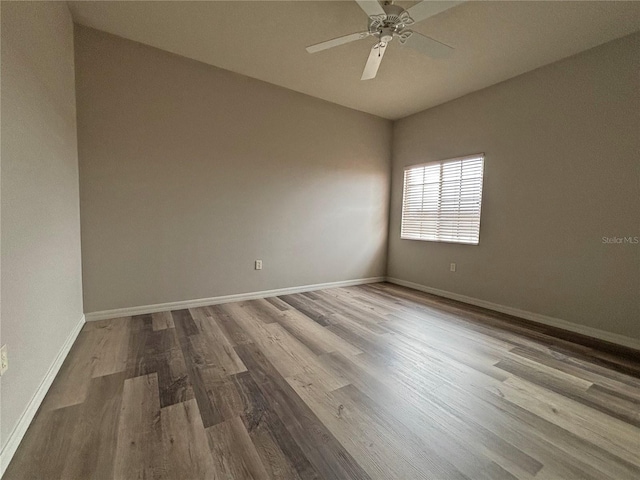 unfurnished room with hardwood / wood-style flooring and ceiling fan