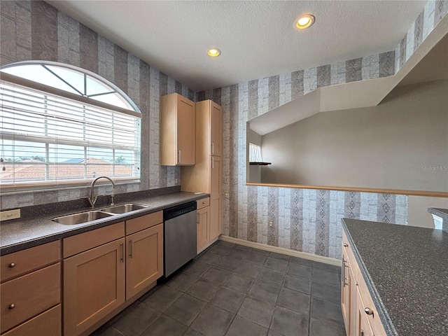 kitchen featuring sink, light brown cabinetry, a textured ceiling, and dishwasher