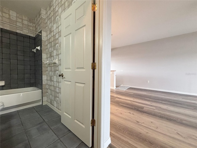 bathroom featuring hardwood / wood-style floors and tiled shower / bath