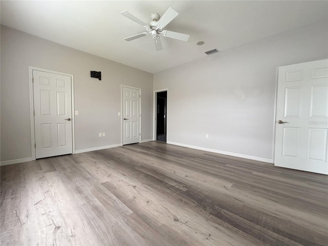 empty room with ceiling fan and wood-type flooring