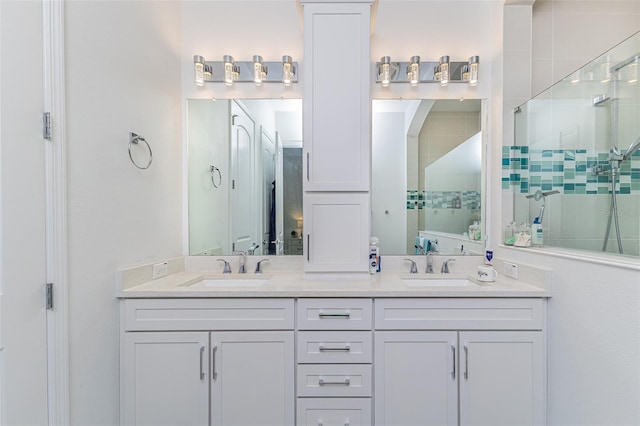 bathroom with tiled shower and vanity