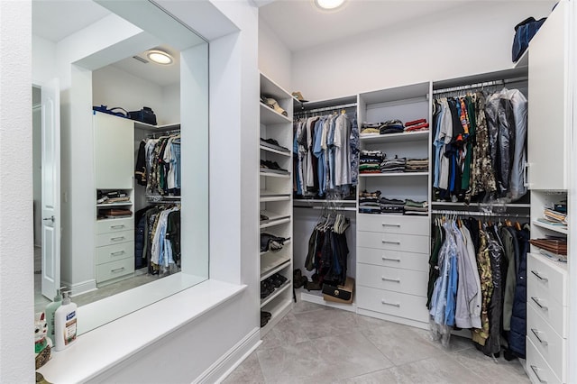 spacious closet with light tile patterned floors