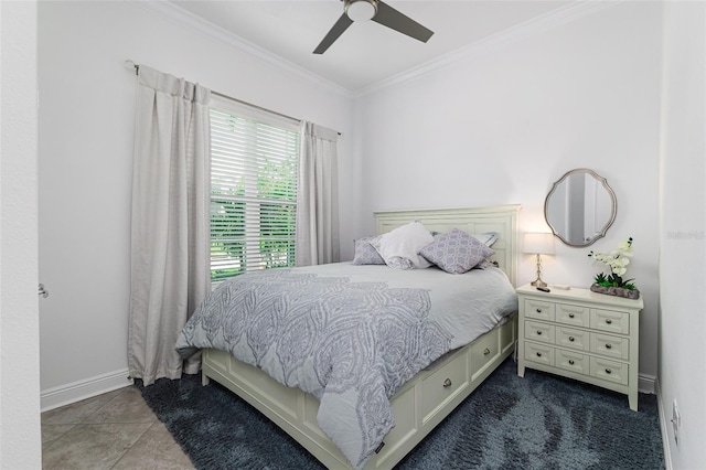 bedroom with ceiling fan, dark tile patterned floors, and crown molding