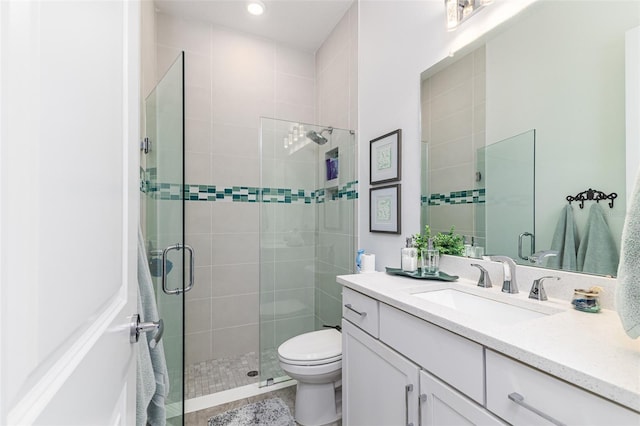 bathroom featuring vanity, toilet, and an enclosed shower