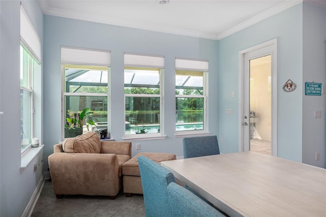 interior space featuring tile patterned flooring, plenty of natural light, ornamental molding, and a water view