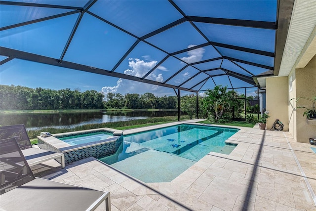 view of pool with glass enclosure, an in ground hot tub, a patio, and a water view