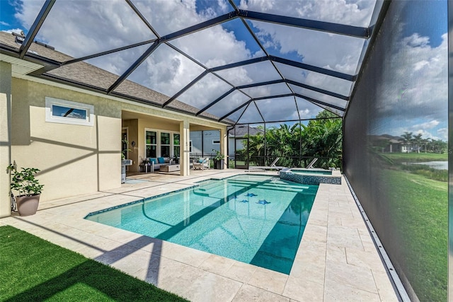 view of pool featuring glass enclosure, an in ground hot tub, an outdoor hangout area, and a patio area