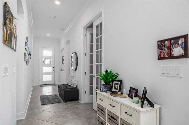 tiled entrance foyer with ornamental molding