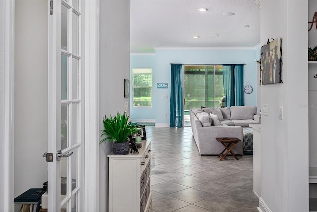 tiled living room with crown molding and a textured ceiling