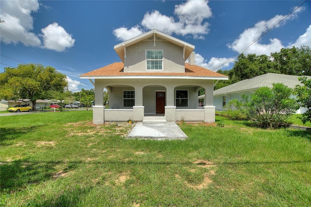 view of front facade with covered porch and a front yard