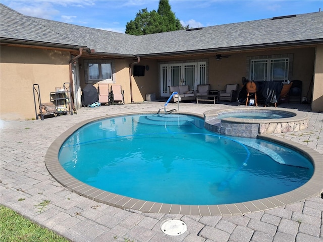 view of pool with an outdoor living space, french doors, ceiling fan, an in ground hot tub, and a patio area