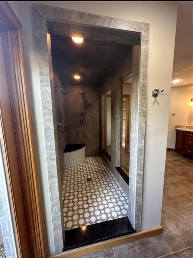 bathroom featuring vanity and a tile shower