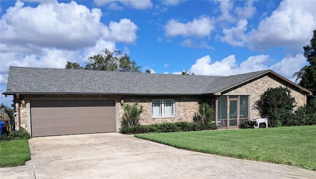 ranch-style home featuring a garage and a front lawn