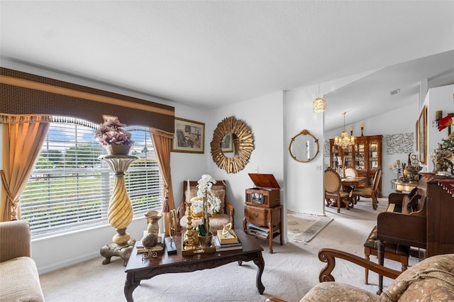 living room with vaulted ceiling, an inviting chandelier, and carpet flooring