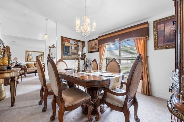 carpeted dining area with lofted ceiling and a chandelier