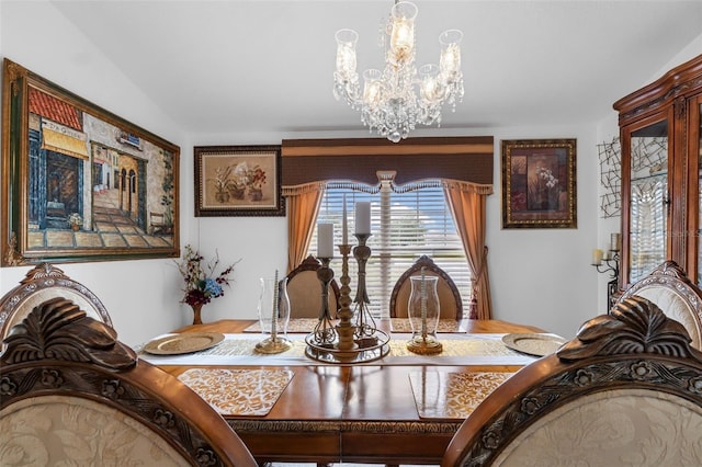 dining space featuring vaulted ceiling and an inviting chandelier