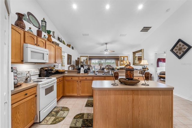 kitchen with white appliances, a kitchen island, ceiling fan, and lofted ceiling