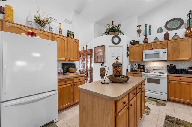 kitchen featuring high vaulted ceiling, light tile patterned floors, white appliances, and a kitchen island