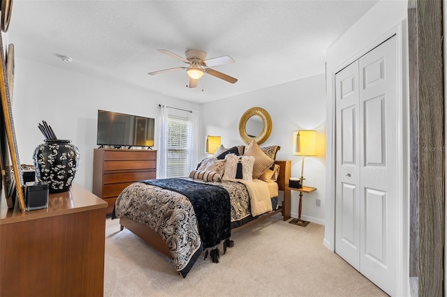 carpeted bedroom featuring a closet and ceiling fan