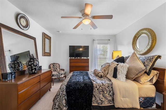 carpeted bedroom with a textured ceiling and ceiling fan