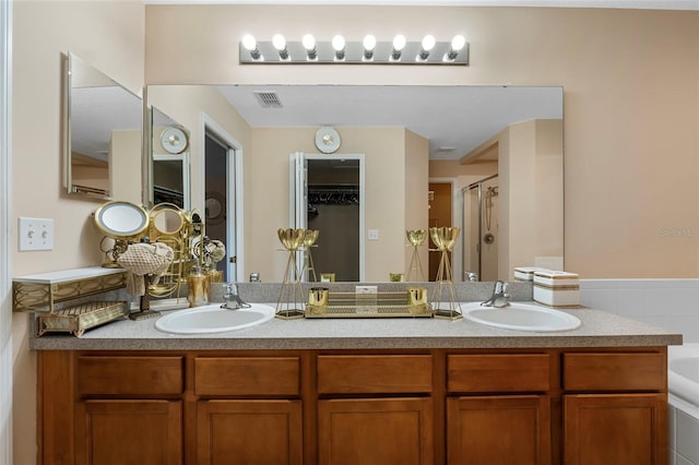 bathroom featuring separate shower and tub and vanity