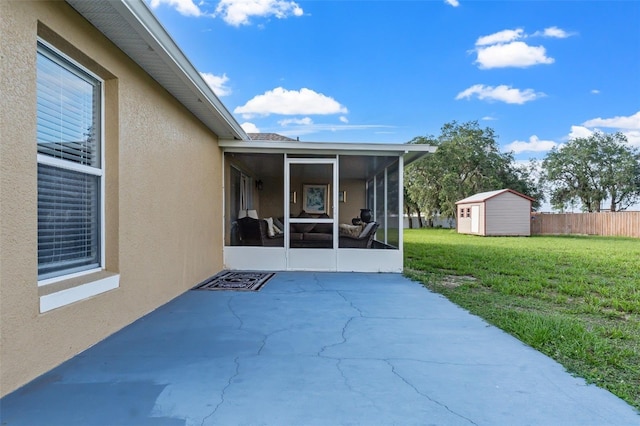 view of patio / terrace with a storage shed and a sunroom