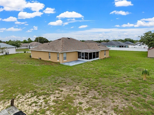 back of house with a lawn and a patio area