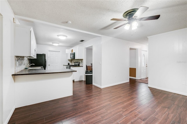 kitchen with a ceiling fan, tasteful backsplash, dark countertops, black appliances, and dark wood-style flooring