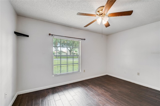 spare room with dark wood-style floors, a textured ceiling, baseboards, and a ceiling fan