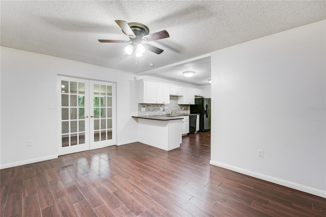 unfurnished living room featuring a textured ceiling, a ceiling fan, dark wood finished floors, a sink, and french doors
