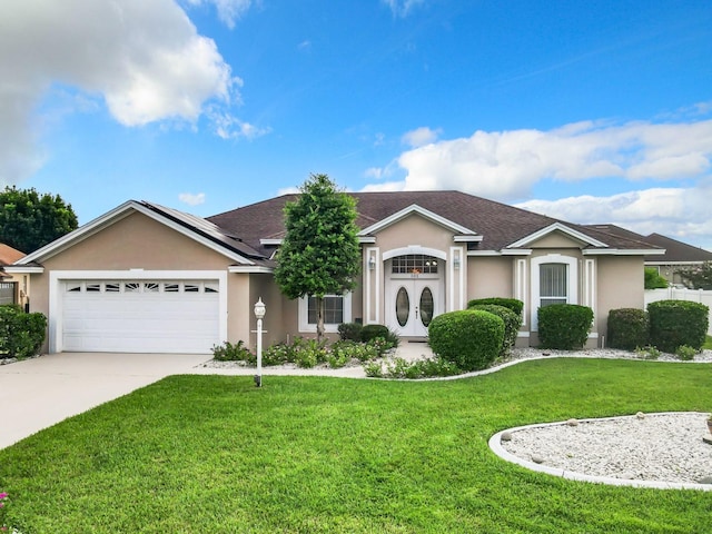 ranch-style house featuring a garage and a front yard