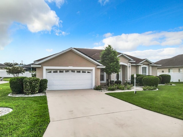 single story home with a front yard, fence, driveway, an attached garage, and stucco siding