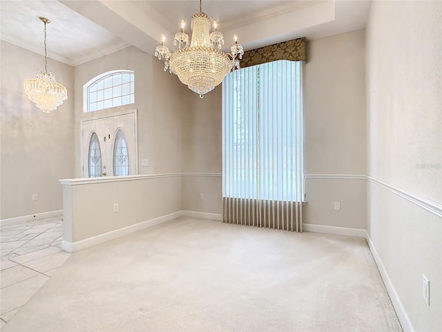 carpeted spare room featuring baseboards and a notable chandelier