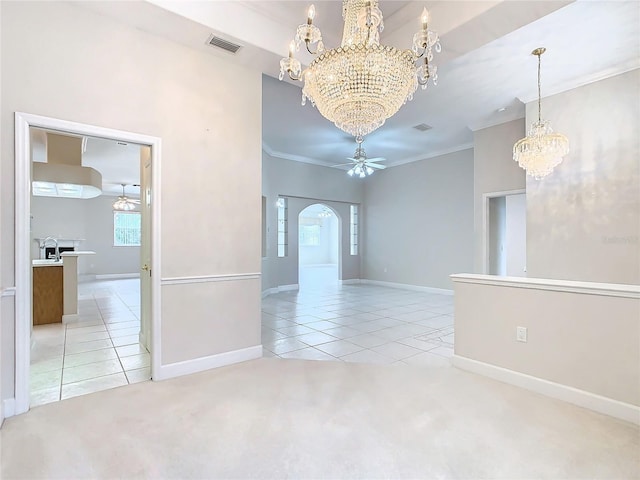 unfurnished room with visible vents, ceiling fan with notable chandelier, arched walkways, light tile patterned floors, and light colored carpet