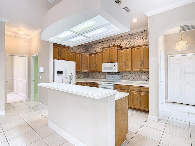 kitchen with light tile patterned floors, visible vents, white appliances, and ornamental molding