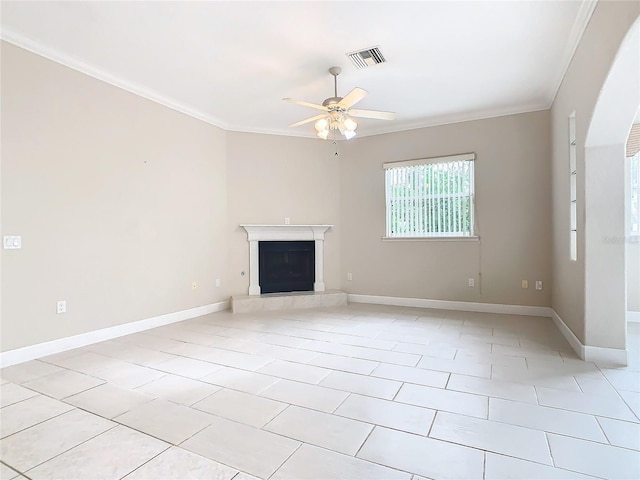 unfurnished living room with crown molding, baseboards, visible vents, and a tile fireplace