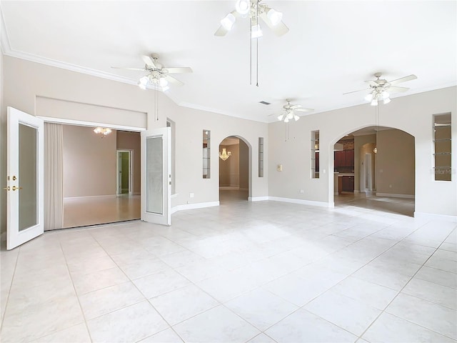 spare room with light tile patterned floors, arched walkways, ceiling fan, and crown molding