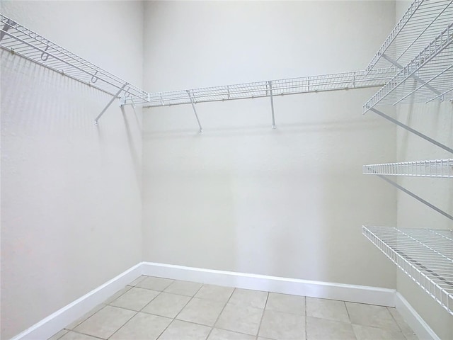 walk in closet featuring light tile patterned floors