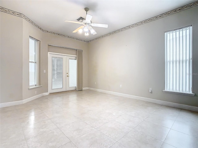 spare room featuring visible vents, french doors, a ceiling fan, and baseboards