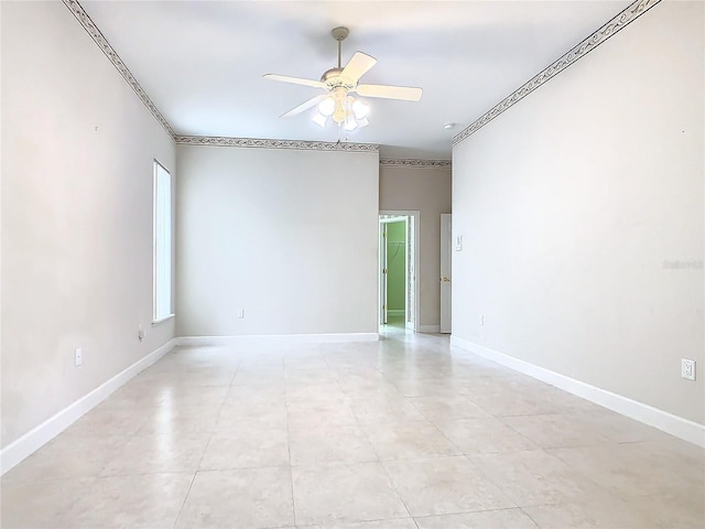 unfurnished room featuring baseboards and a ceiling fan