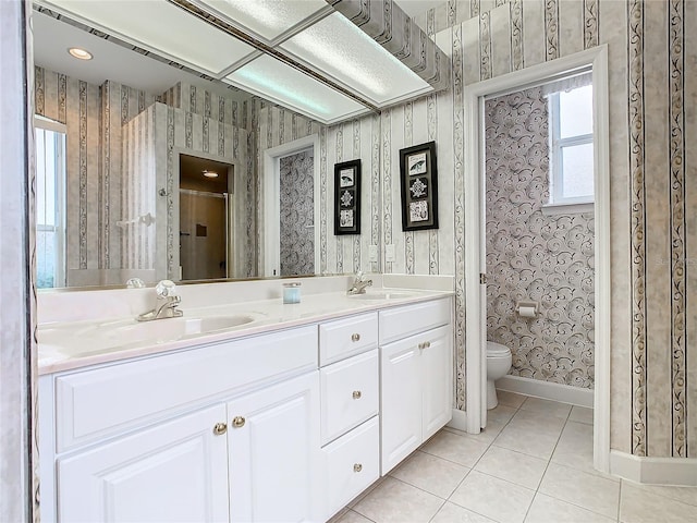 full bathroom featuring a sink, toilet, tile patterned flooring, and wallpapered walls