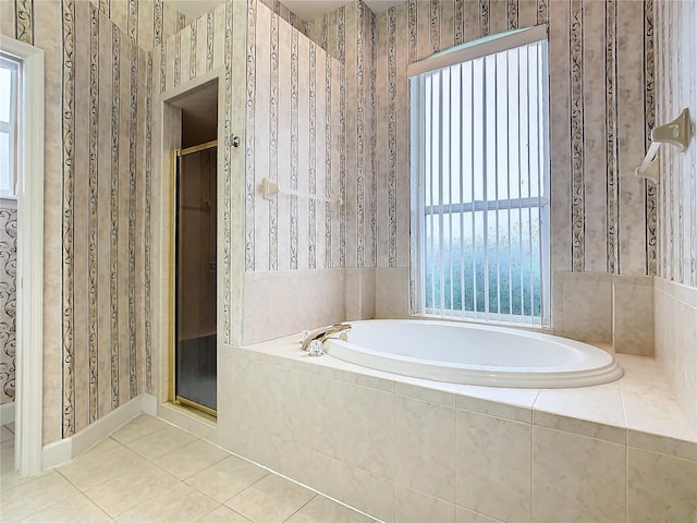 full bath with tile patterned floors, a shower stall, wallpapered walls, and a bath