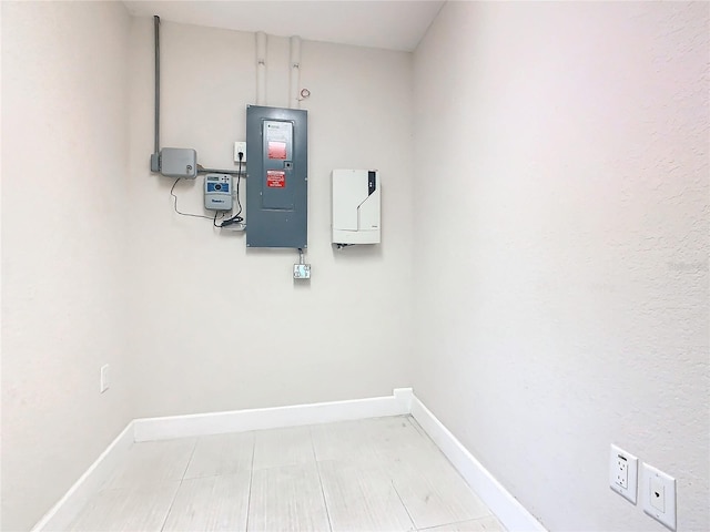 washroom featuring electric panel and baseboards