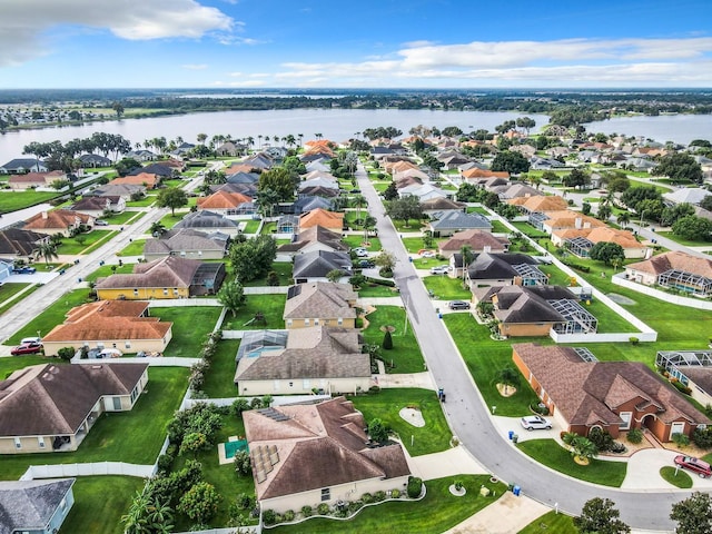 birds eye view of property with a residential view and a water view