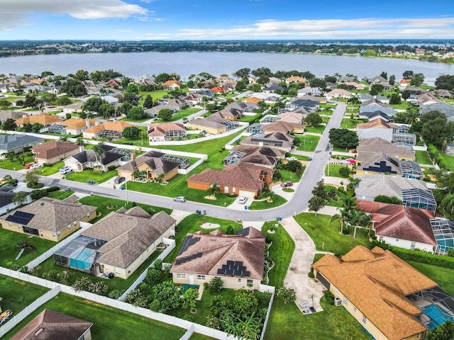 drone / aerial view with a residential view and a water view