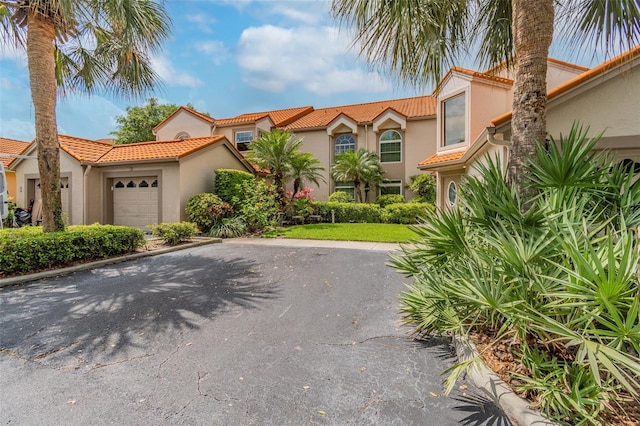 mediterranean / spanish-style home featuring a garage