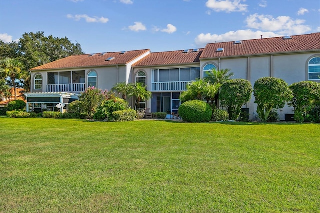 rear view of house with a lawn